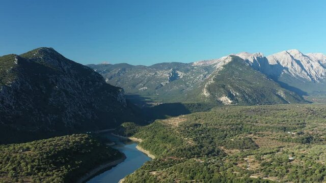View from above, stunning aerial view of the Cedrino Lake - Lago del Cedrino, surrounded by the mountain range of Supramonte located northeast of the Gennargentu massif. Sardinia, Italy.