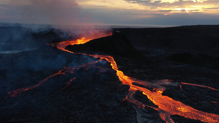 Aerial view over volcanic eruption, Night view, Mount Fagradalsfjall
lava spill out of the crater  Mount Fagradalsfjall, September 2021, Iceland 
