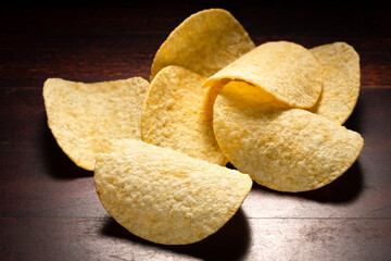 close up potato chips snacks on a wooden background