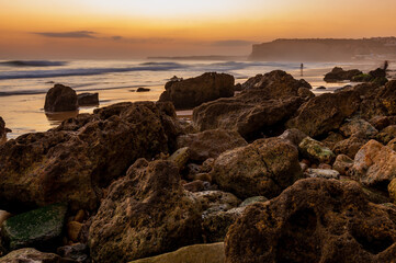 Sunset over the beach of Porto de Mos Algarve Portugal.