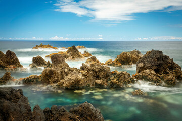 Obraz premium Porto Moniz natural pools, with horizon, soft ocean water and color