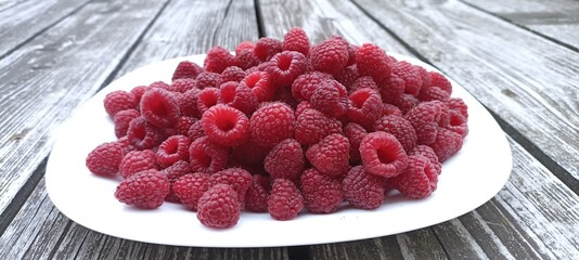 Garden large raspberries of a dark saturated color close up