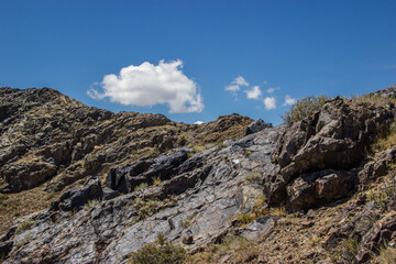 Beautiful Summer scenery: rocky mountains under the blue cloudy sky