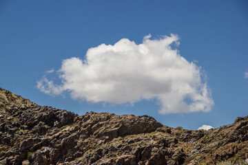 Fototapeta na wymiar Beautiful Summer scenery: rocky mountains under the blue cloudy sky