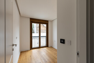 White walls, wooden floor, empty apartment interior