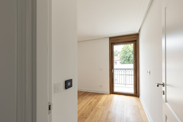 White walls, wooden floor, empty apartment interior