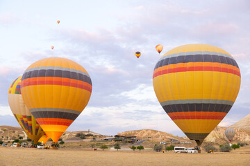 Hot air balloons launching at sunrise in Cappadocia, Turkey