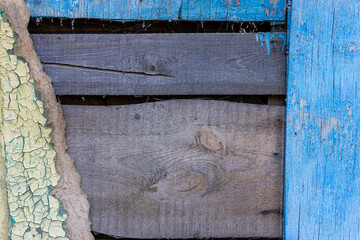 Destroyed wooden wall. Damaged wood surface. Texture of an old shabby wooden board.