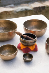 Authentic Tibetan singing bowls prepared for an alternative therapy. Vertical photo.