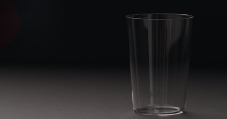 empty tumbler glass on black backgorund