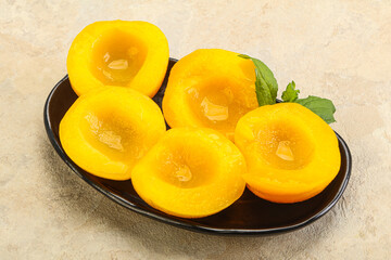 Sweet ripe canned peaches with mint