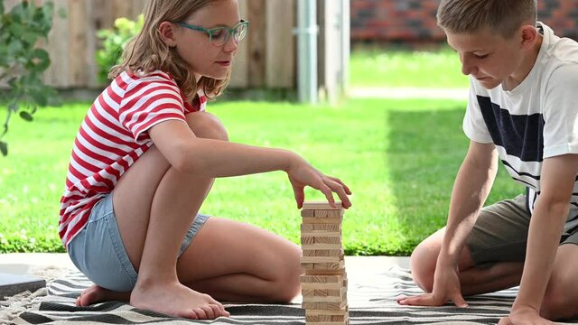 4K 60fps video of two happy children playing with wooden blocks. Having fun together