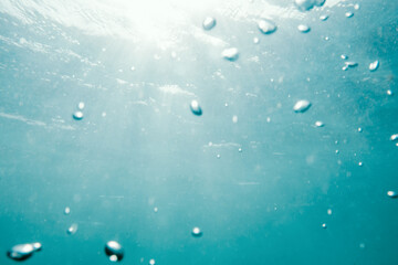 Underwater View of Bubbles In Deep Blue Ocean. Close Up Water. Background