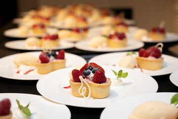 A large number of strawberry tart desserts