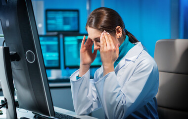 Workplace of young woman in modern microelectronics manufacturing lab. Engineer works in a modern...