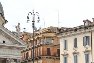 Fototapeta na wymiar Via Margutta Buildings Close Up with Santa Maria dei Miracoli Church Detail with Statue in Rome, Italy