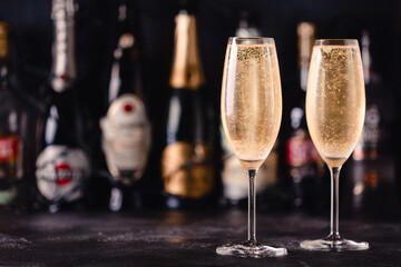 Champagne glasses on a dark background.