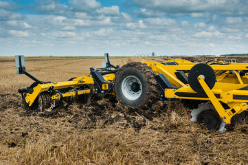 cultivator at work, close up of a disc harrow on a field background