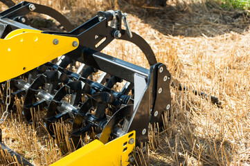 cultivator at work, close up of a disc harrow on a field background