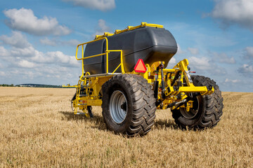 fragment of the tillage system trailed hopper for fertilizers in the field