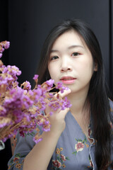 close up portrait of asian cute and sexy girl with flowers on isolated background