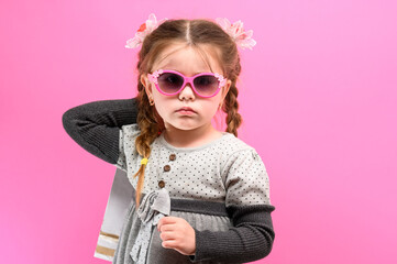 Little girl shopping, baby portrait on pink background, baby shopping.