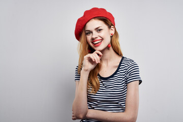 pretty woman in a striped t-shirt red lips gesture with his hands isolated background
