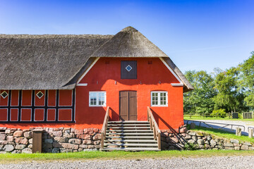 Steps in front of the red farmstead of Fyrkat near Hobro, Denmark