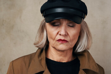 pretty elderly woman in coat black hat fashion