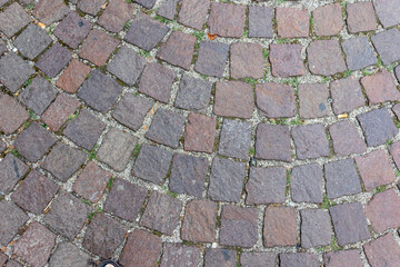 Old cobblestone pavement close-up background and texture