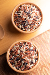 Jasmine Brown Rice in wooden bowl with copy space, Thai rice varieties Top view