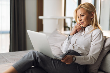 Young businesswoman using a laptop in a hotel room