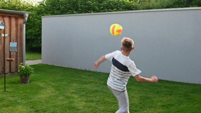 4K video of happy little boy practice his feint and tricks competition with ball at backyard during summer holidays