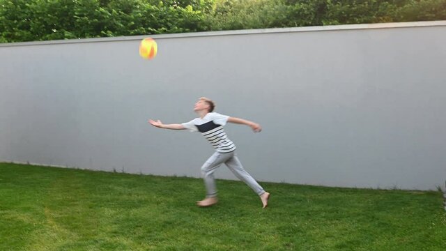 4K video of happy little boy practice his feint and tricks competition with ball at backyard during summer holidays