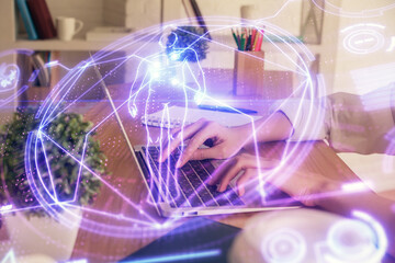 Double exposure of woman hands typing on computer and general theme hologram drawing. Education concept.