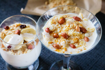 Delicious and healthy yogurt dessert with banana, biscuits and nuts.
