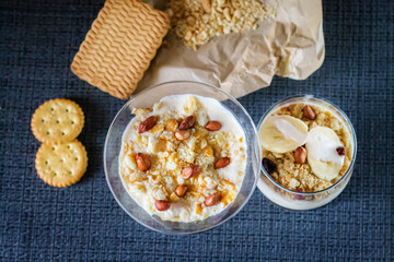 Delicious and healthy yogurt dessert with banana, biscuits and nuts.
