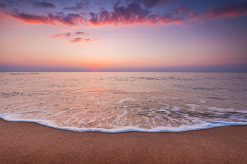 Beautiful sunrise over the sea waves and beach