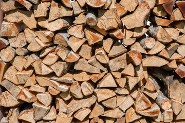 Background of dry chopped firewood logs in a pile