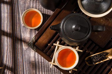 cups of green tea and teapot on  table