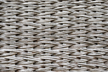 a wicker surface made of wooden rods. the texture of the wicker surface