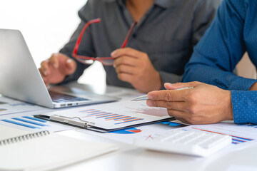 Business people discussing working and presenting the charts and graphs showing the results of their successful teamwork, the discussion aimed at reaching an agreement, Business concept.