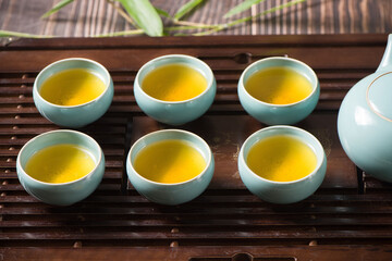 cups of green tea and teapot on  tea tray 