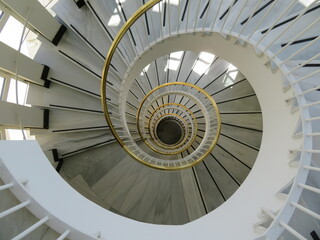 beautiful spiral staircase with golden handrails design circular shapes