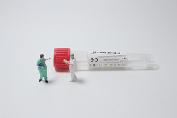 a figure of doctor with the collection tubes