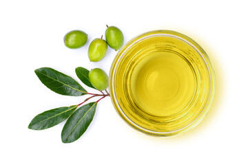 Extra virgin olive oil in glass bowl and green olive fruit with leaves isolated on white...