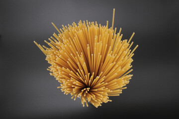 A Directly above shot of raw spaghetti on dark background