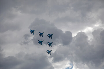 Combat aircraft are flying against the background of the sky. Cloudy sky. Beautiful fighters.