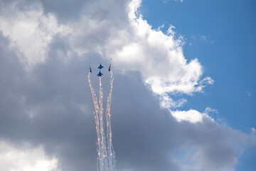 Combat aircraft are flying against the background of the sky. Cloudy sky. Beautiful fighters.