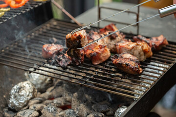 A barbecue grill with tasty juicy steaks are grilled over an open fire.